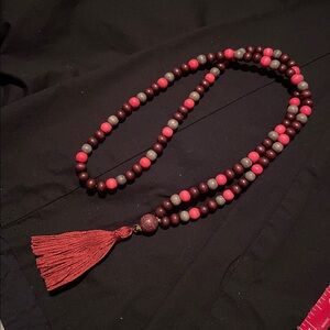 Hand assembled beaded necklace burnt amber cotton tassel